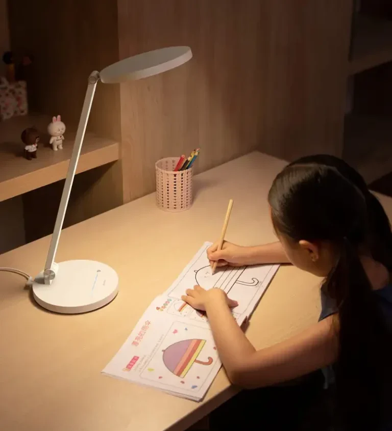 Baseus DGHY-02 Desk Lamp Study Lifestyle Child colouring at a wooden desk illuminated by a white Baseus DGHY-02 desk lamp