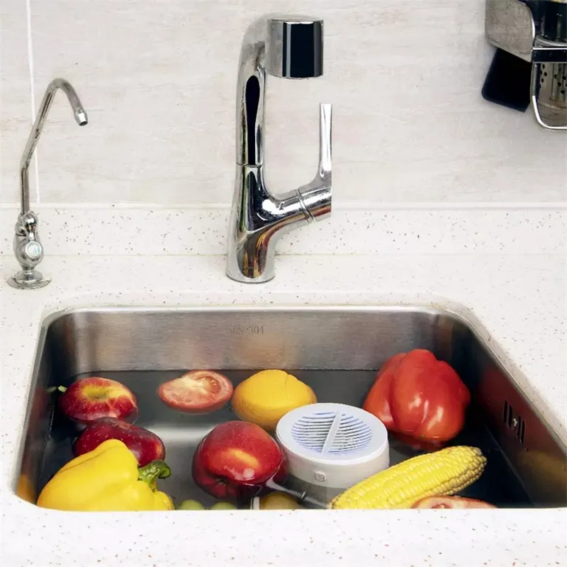 Xiaomi Portable Fruit and Vegetable Cleaner – Kitchen Sink Display White portable fruit and vegetable cleaner in a water-filled kitchen sink with apples, peppers and corn