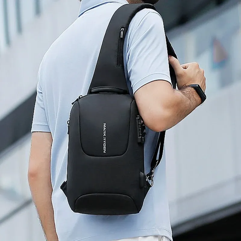 Mark Ryden MR-7039 Sling Bag Back Carry View Man wearing a black Mark Ryden MR-7039 sling bag across his back over a light blue polo shirt