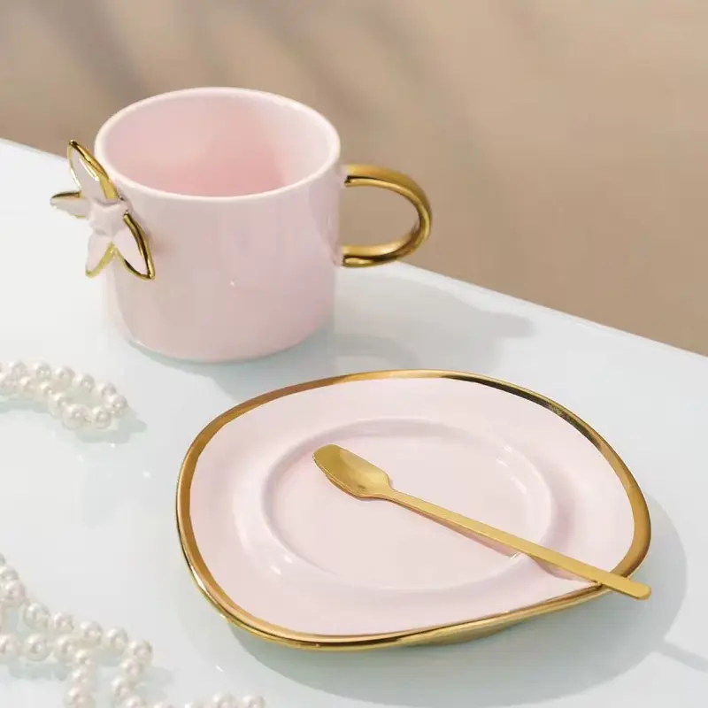 Pink cup with gold accents and plate