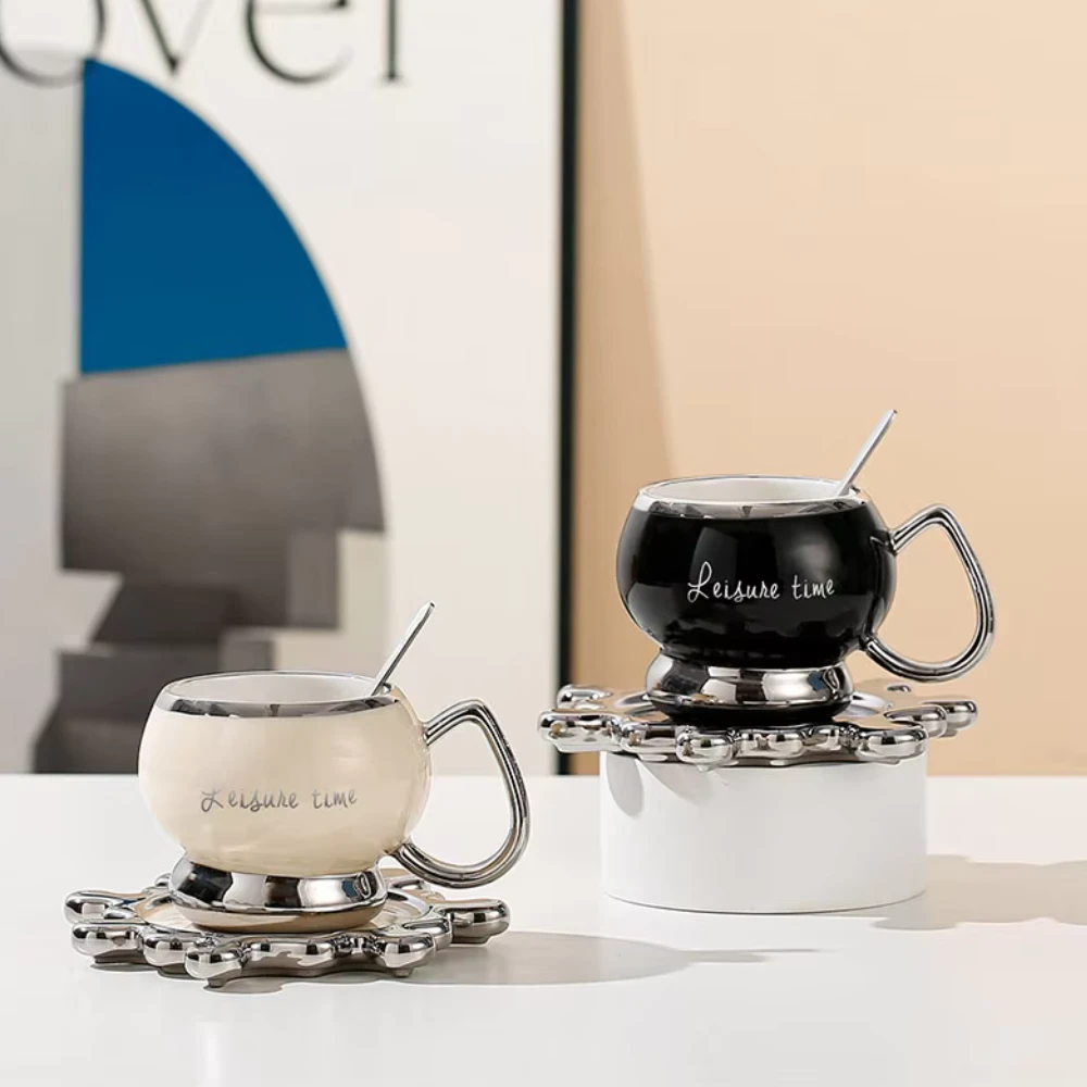 Two stylish coffee cups on saucers.