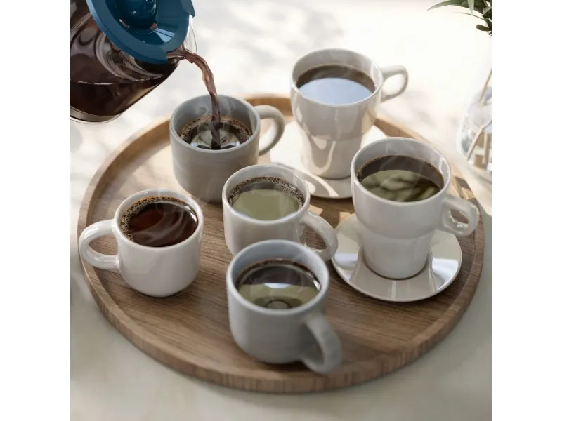 Philips HD7411 Coffee Maker – Coffee Serving Coffee poured from a blue-handled glass jug into one of six white cups on a round wooden tray
