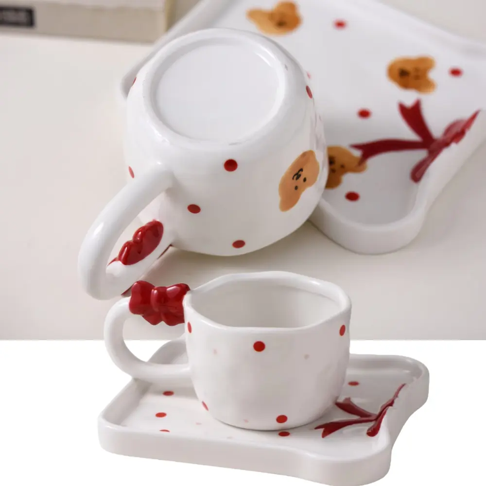 Red Bow Cup and Tray Set Design Comparison Two-panel image of bear-pattern and polka-dot cup and tray sets with red bows