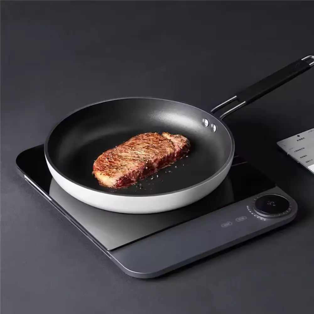 Xiaomi Mijia MCL04M Cooking Setup Xiaomi Mijia MCL04M induction cooker with cookware on its cooking zone