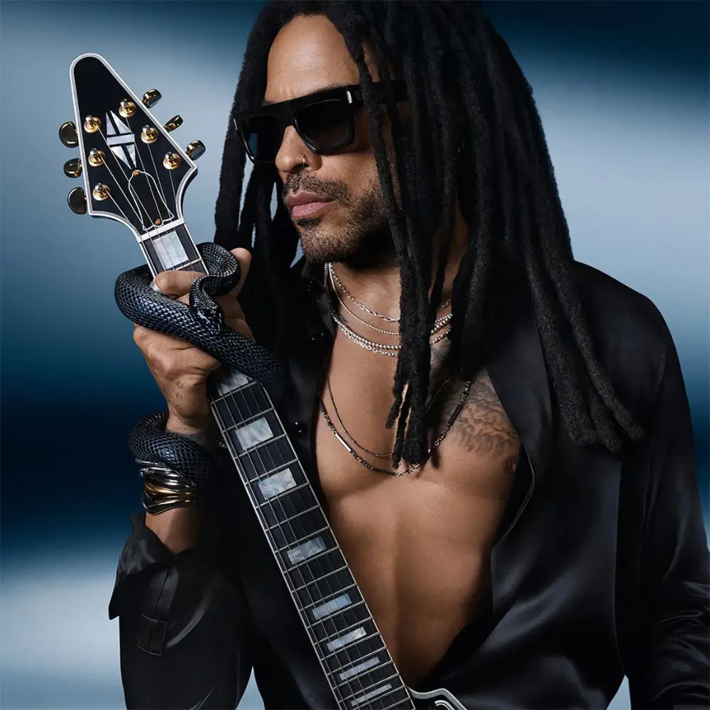 YSL Y EDP for Men Campaign Portrait YSL Y campaign portrait of a man wearing sunglasses and holding an electric guitar